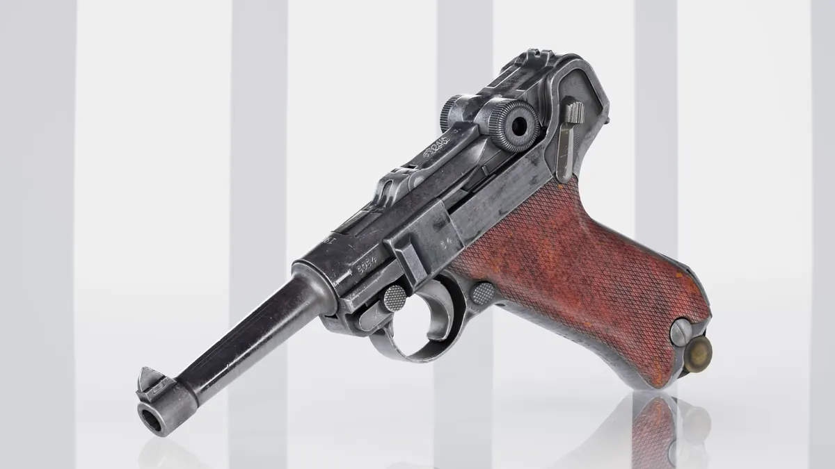Luger style pistol with wooden grip photographed on a white studio background